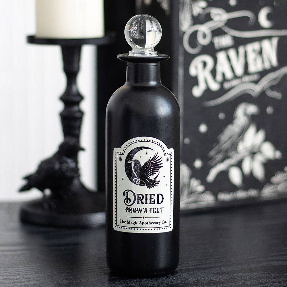 Bouteille de potion en verre gothique décorative avec pattes d'oie séchées